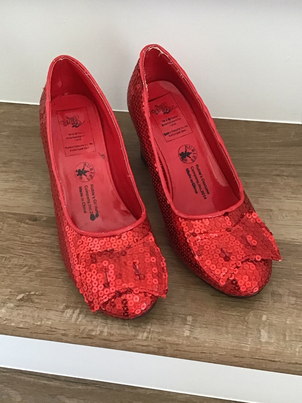 Red sequined costume shoes resembling Ruby Slippers
